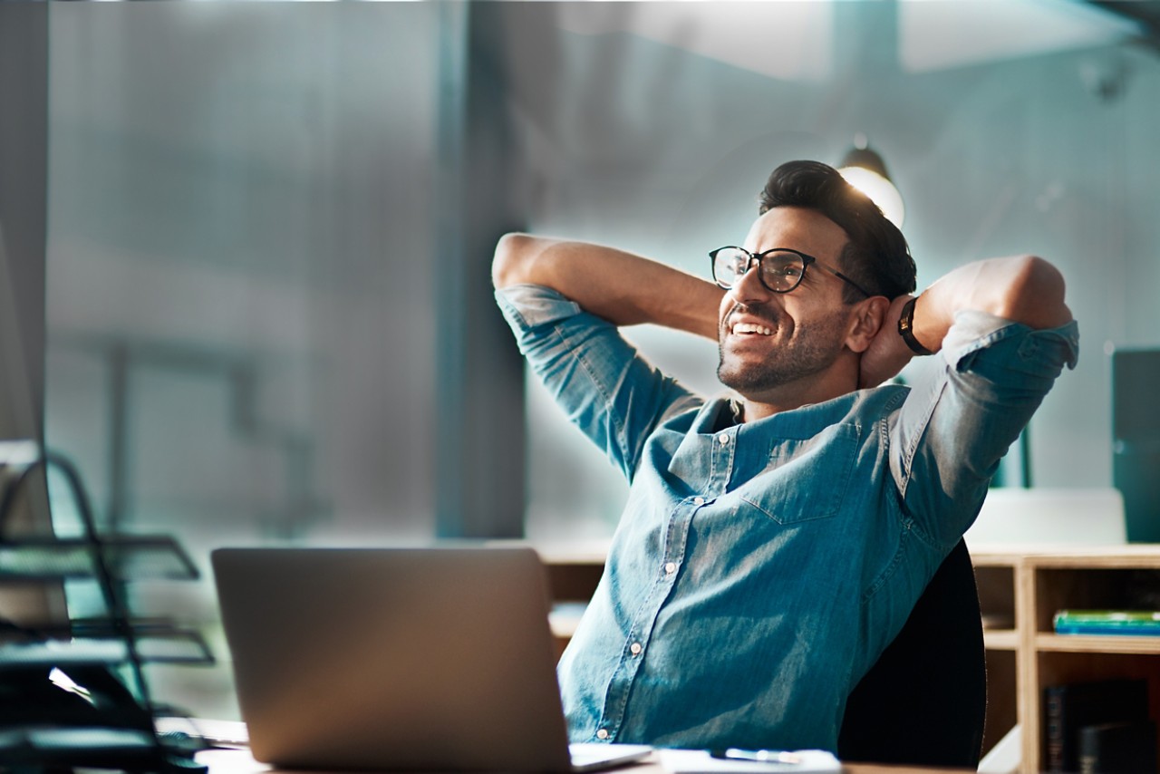 man-hands-behind-head-smiling-getty-874811654