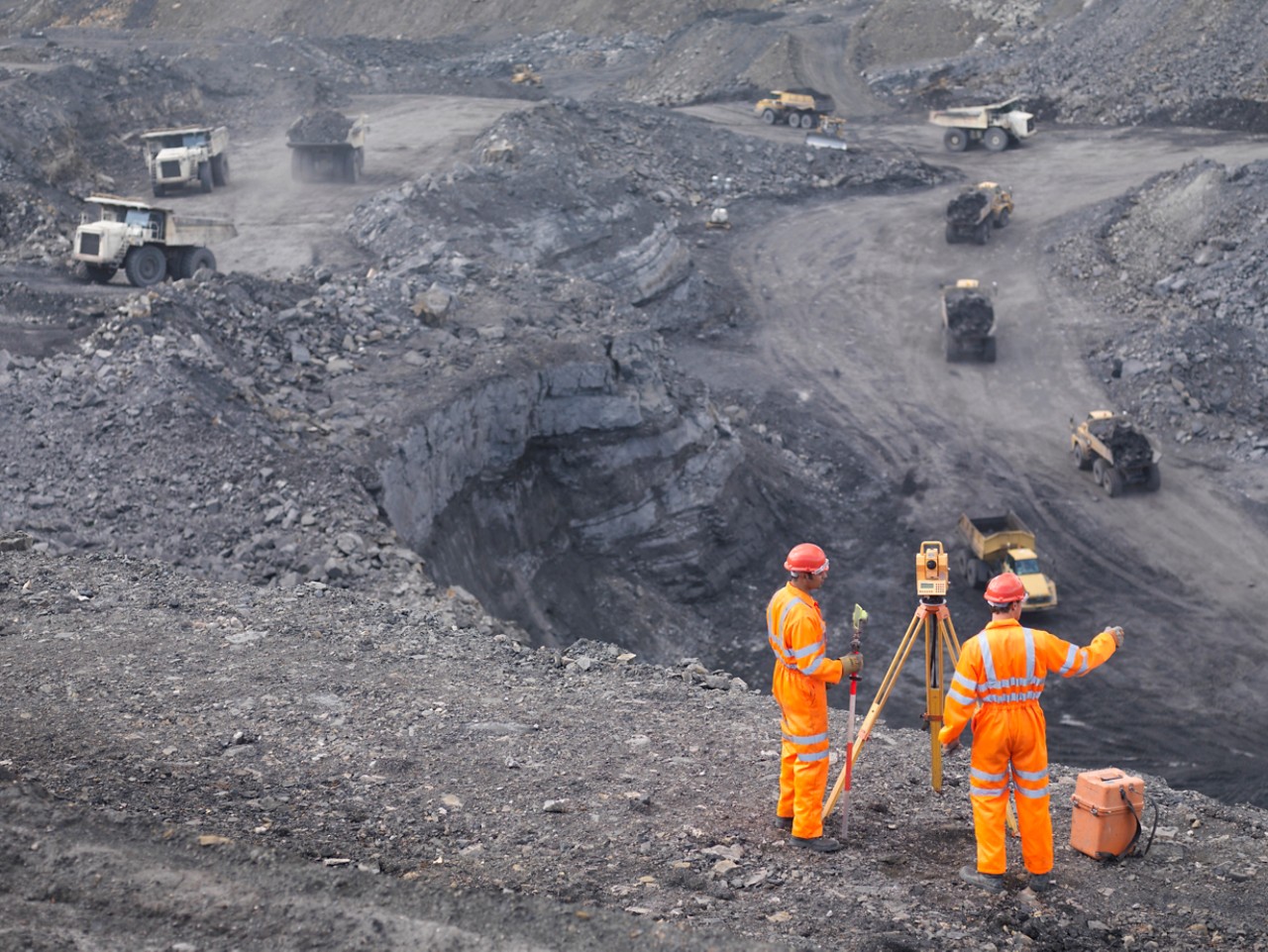 Surface mining operations engineers survey equipment